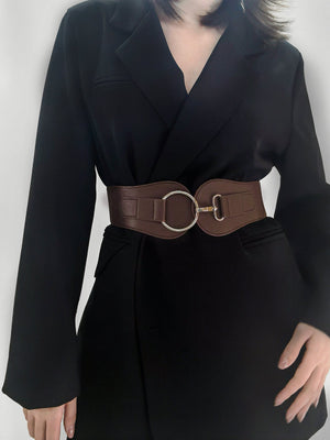 Brown cincher belt with silver ring buckle detail worn over a black blazer