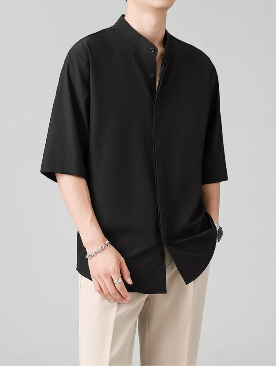 Black oversized half-sleeve shirt with Mandarin collar and button-down front.