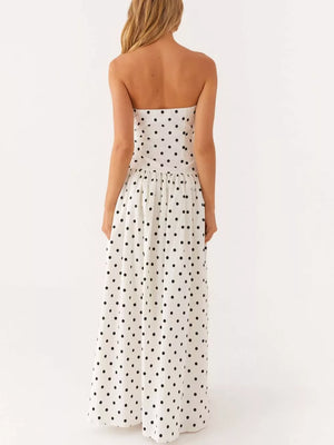 White polka dot strapless maxi dress with a tiered skirt.