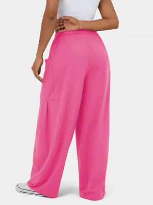 Rose red maternity pants with wide legs and cargo pockets.
