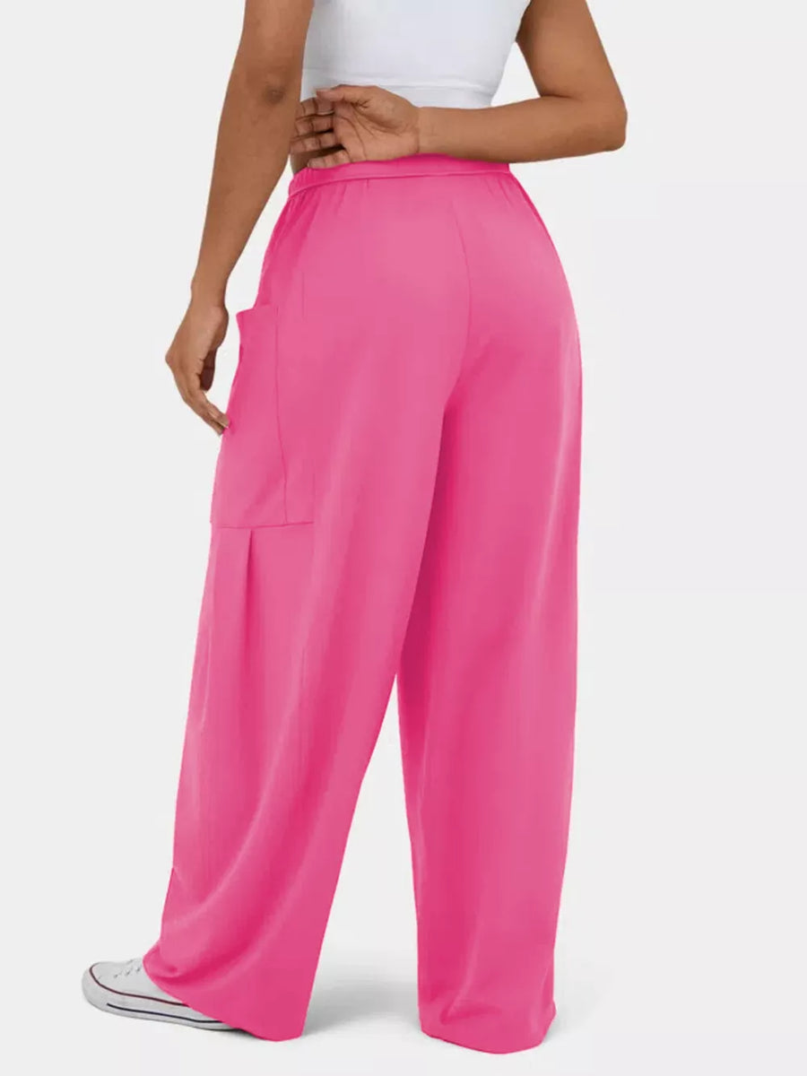 Rose red maternity pants with wide legs and cargo pockets.