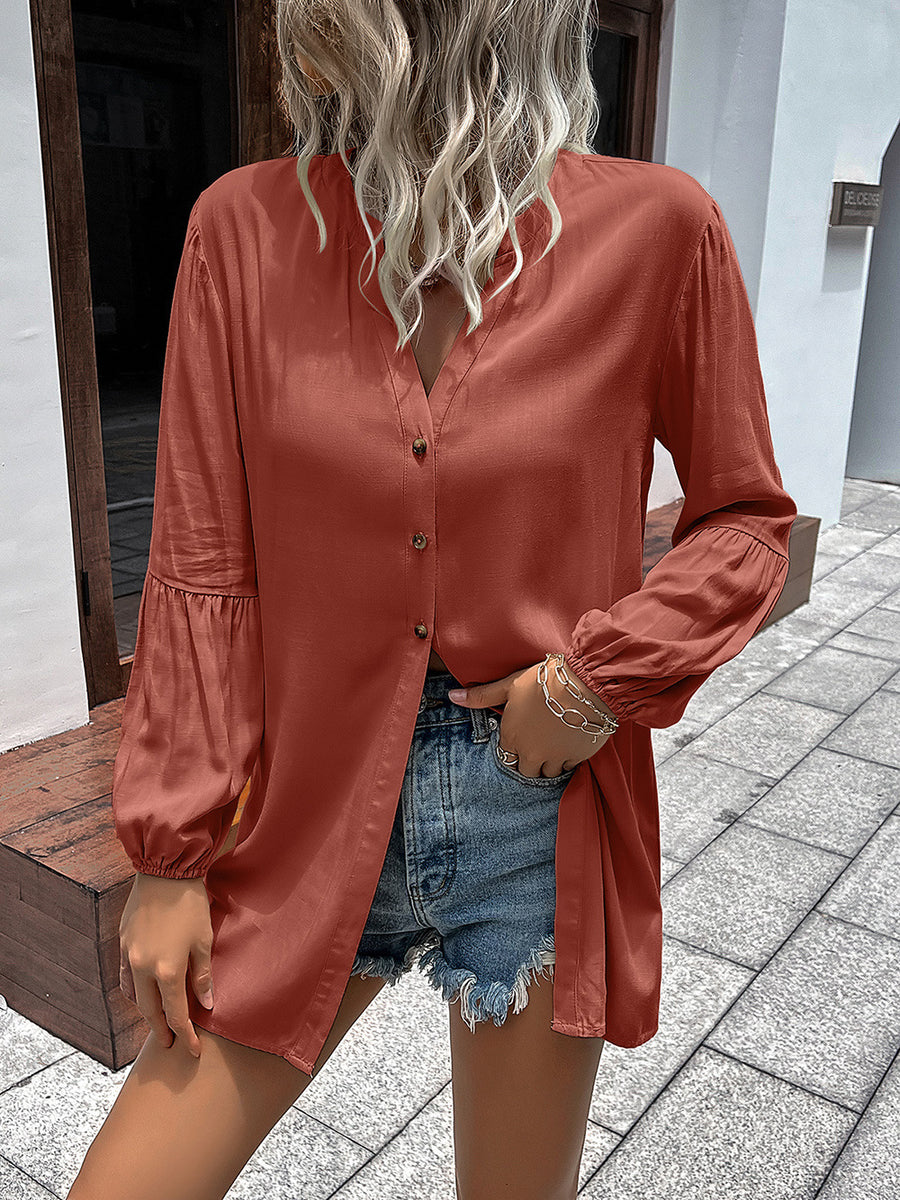 Oversized rust blouse with mandarin collar, button front, and balloon sleeves.