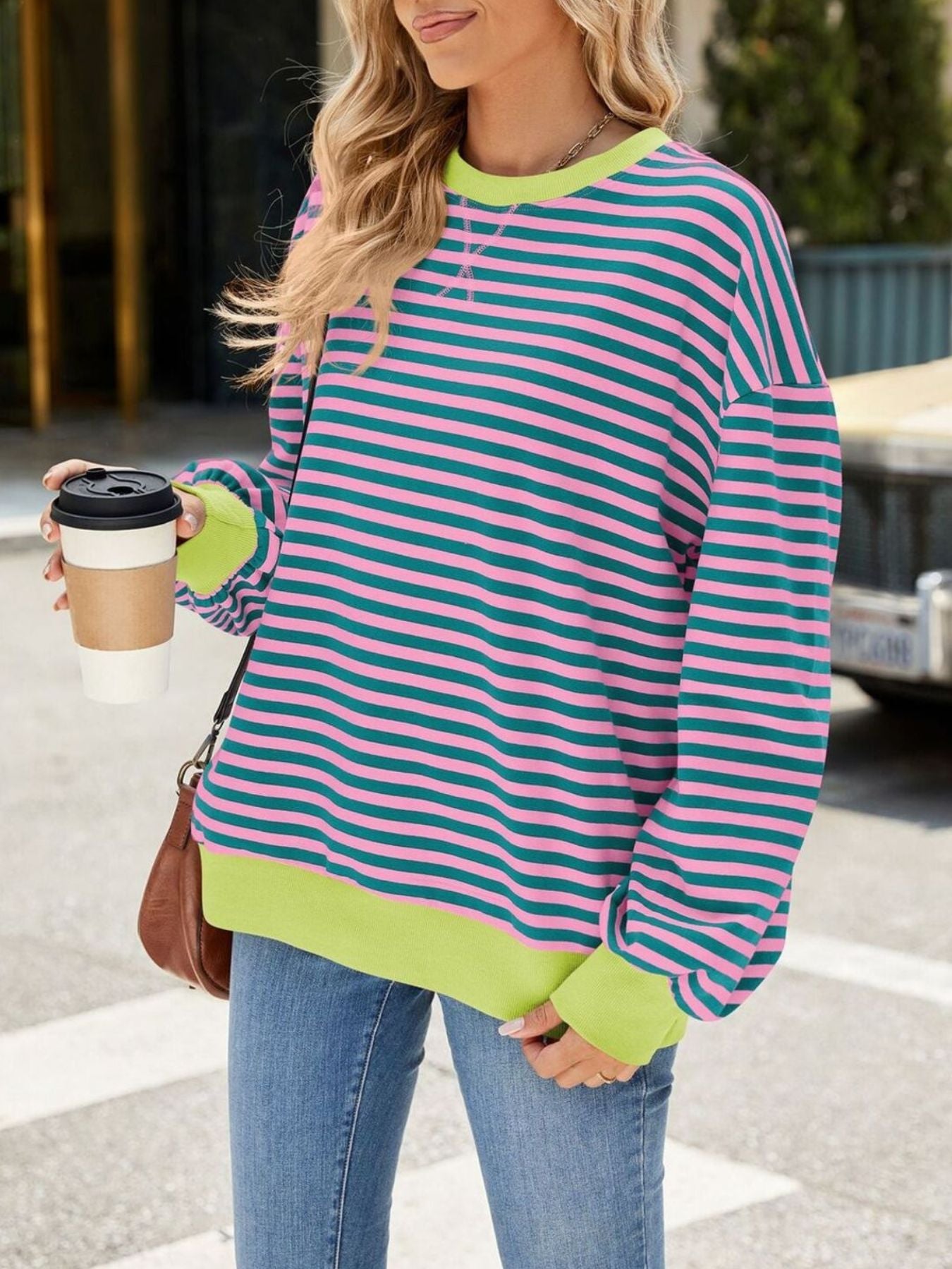 Striped crew neck sweatshirt with pink and teal stripes and neon green trim.