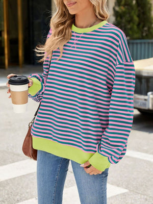 Striped crew neck sweatshirt with pink and teal stripes and neon green trim.