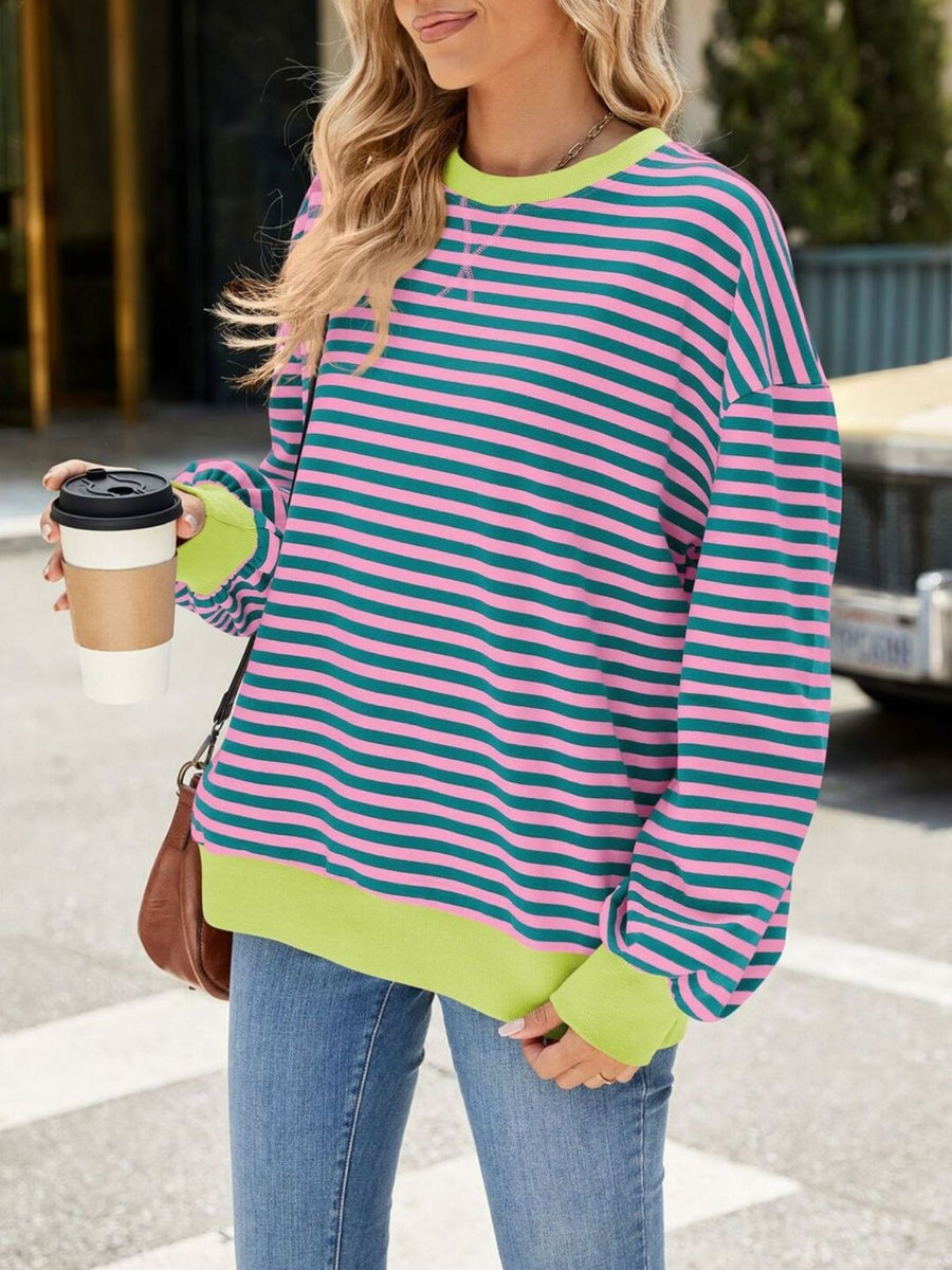 Striped crew neck sweatshirt with pink and teal stripes and neon green trim.