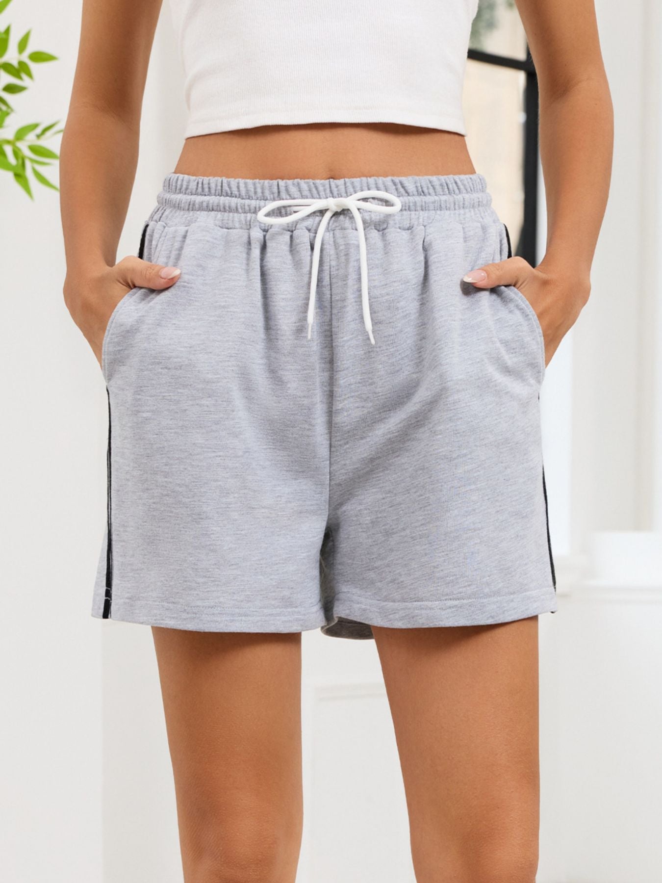 Heathered gray jogger shorts with drawstring and sporty side trim.