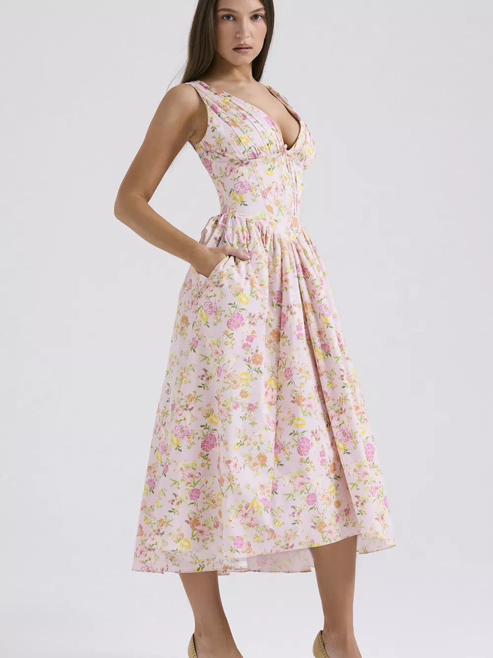 Floral print midi dress in pink with V-neck and pockets.