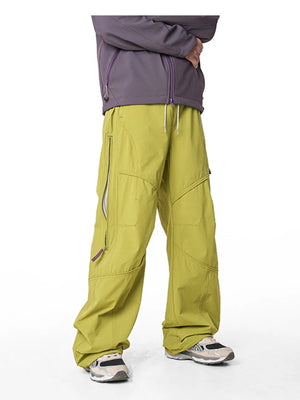 Relaxed fit cargo pants in Mustard Yellow with drawstring and zippered pockets.