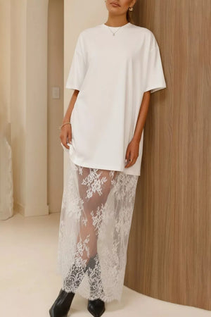 White cotton midi t-shirt dress with sheer lace overlay skirt and short sleeves.