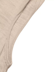 Beige midi dress detail showing textured fabric and seam.