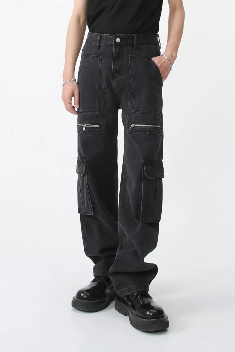 Dark denim wide-leg cargo pants with zip pockets and flap pockets.