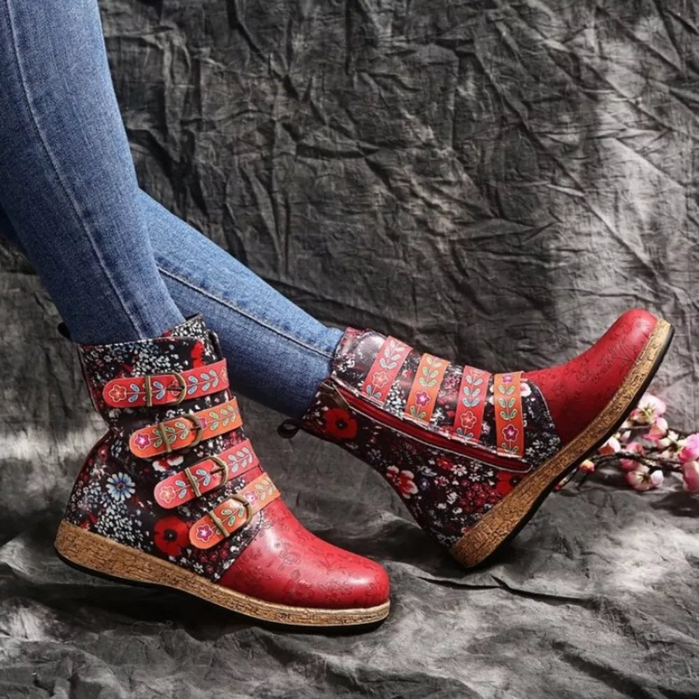 Red embroidered suede ankle boots with floral accents and decorative straps.