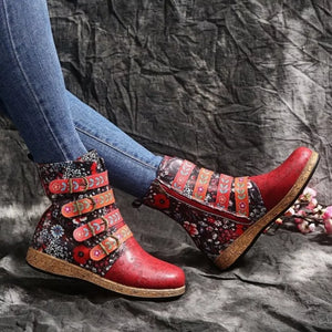 Red embroidered suede ankle boots with floral accents and decorative straps.