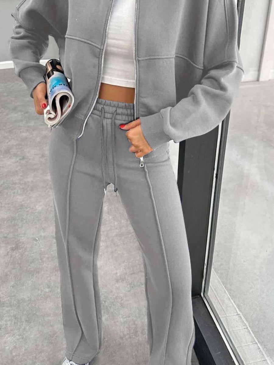 Gray bomber jacket and wide-leg tracksuit with drawstring waist and zippered ankles.