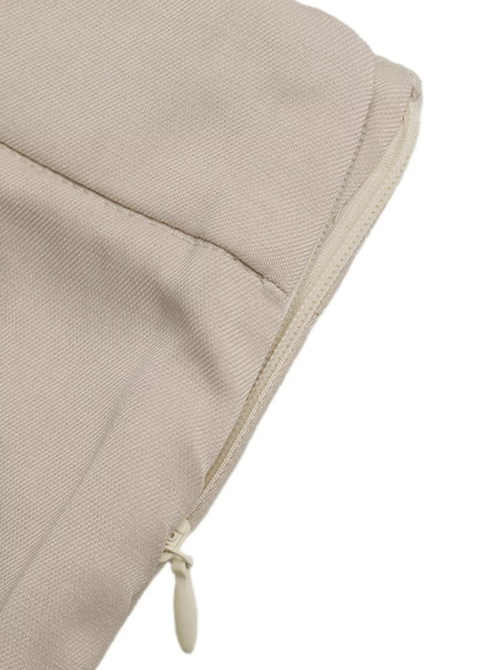 Beige polyester sleeveless wrap top and shorts ensemble with side zipper detail.