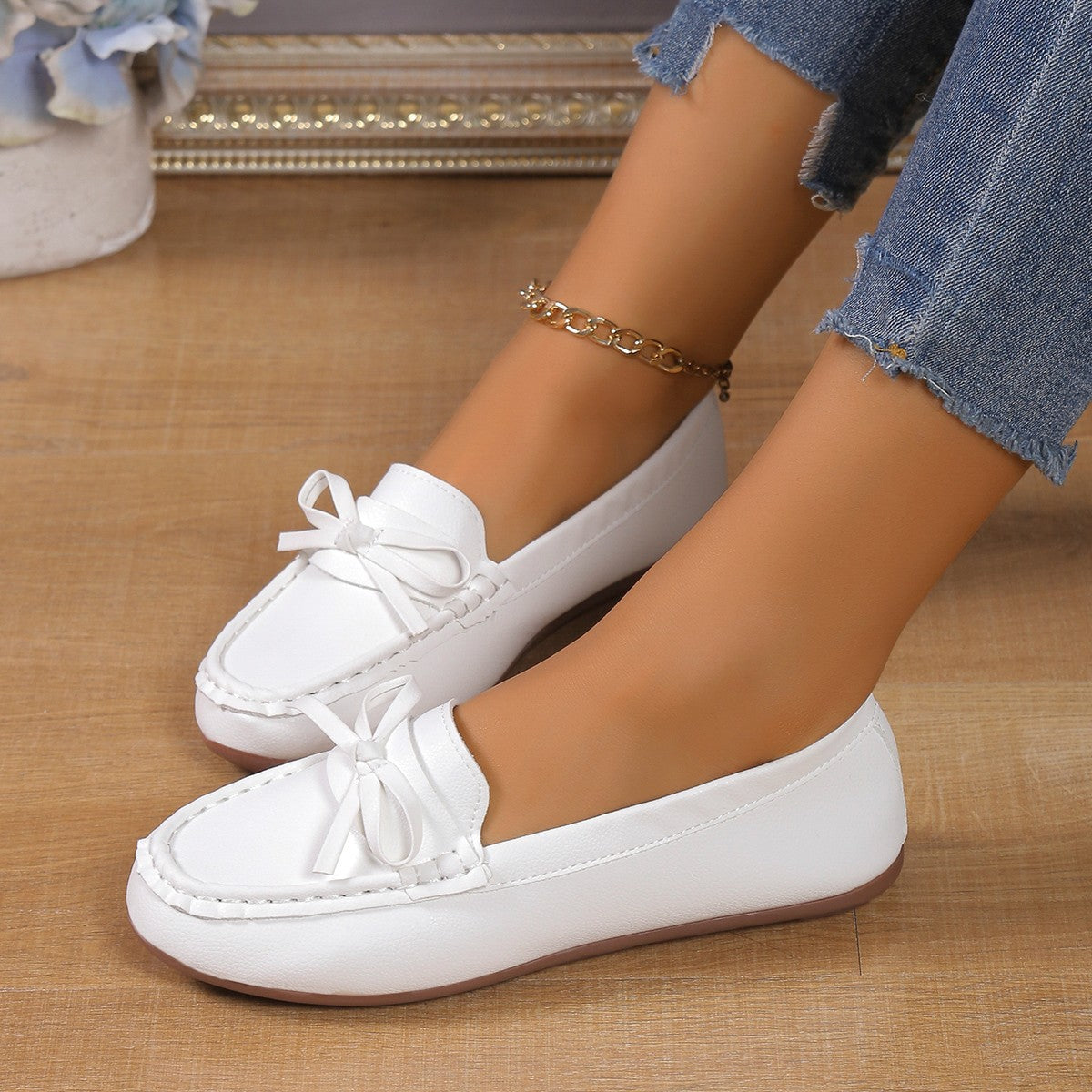White bow embellished flat slip-on loafers with a comfortable casual style.