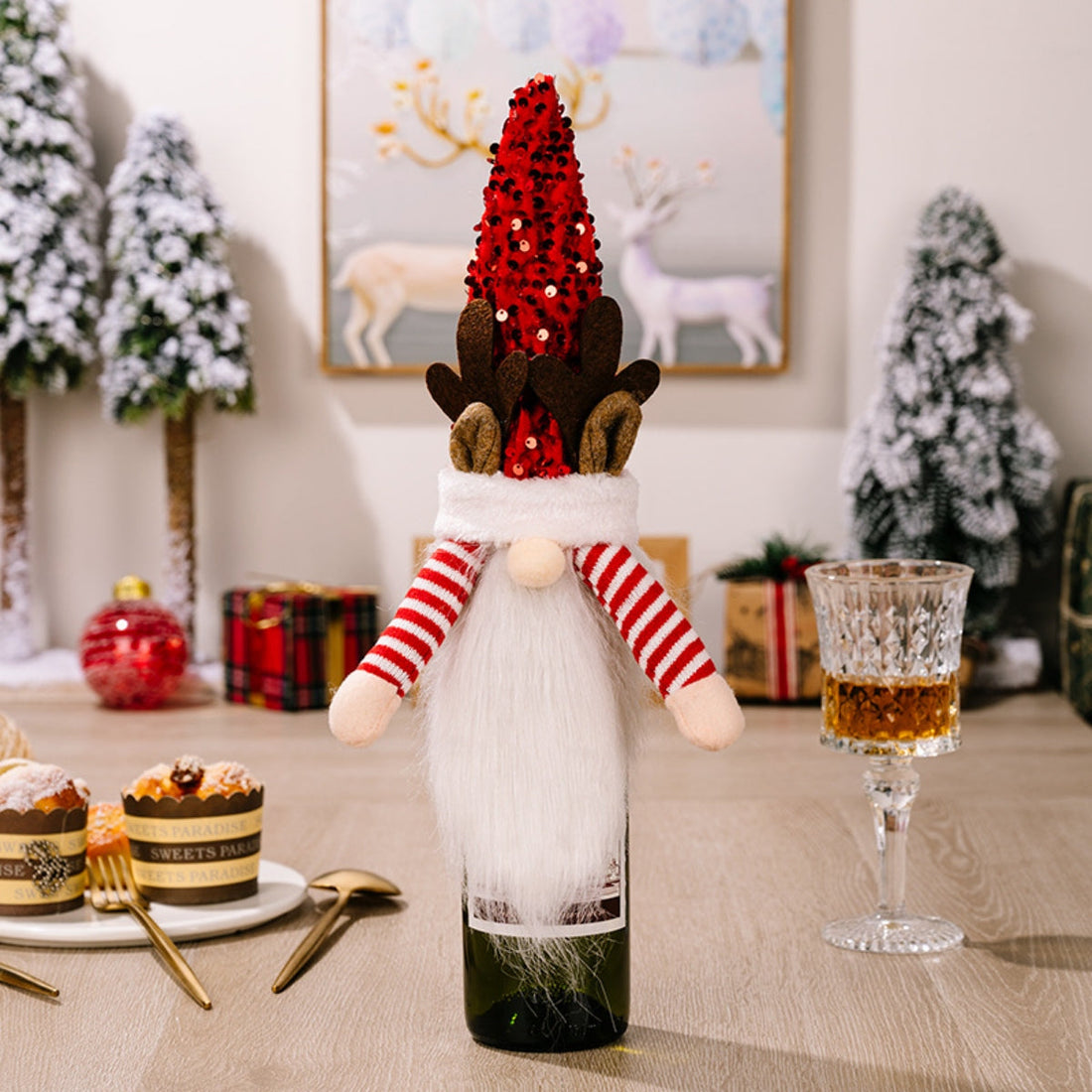 Festive gnome bottle topper in deep red with white beard and striped arms.
