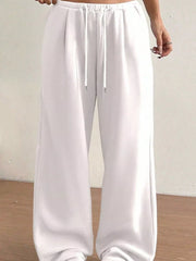 White wide-leg maternity joggers with drawstring waist and relaxed fit.