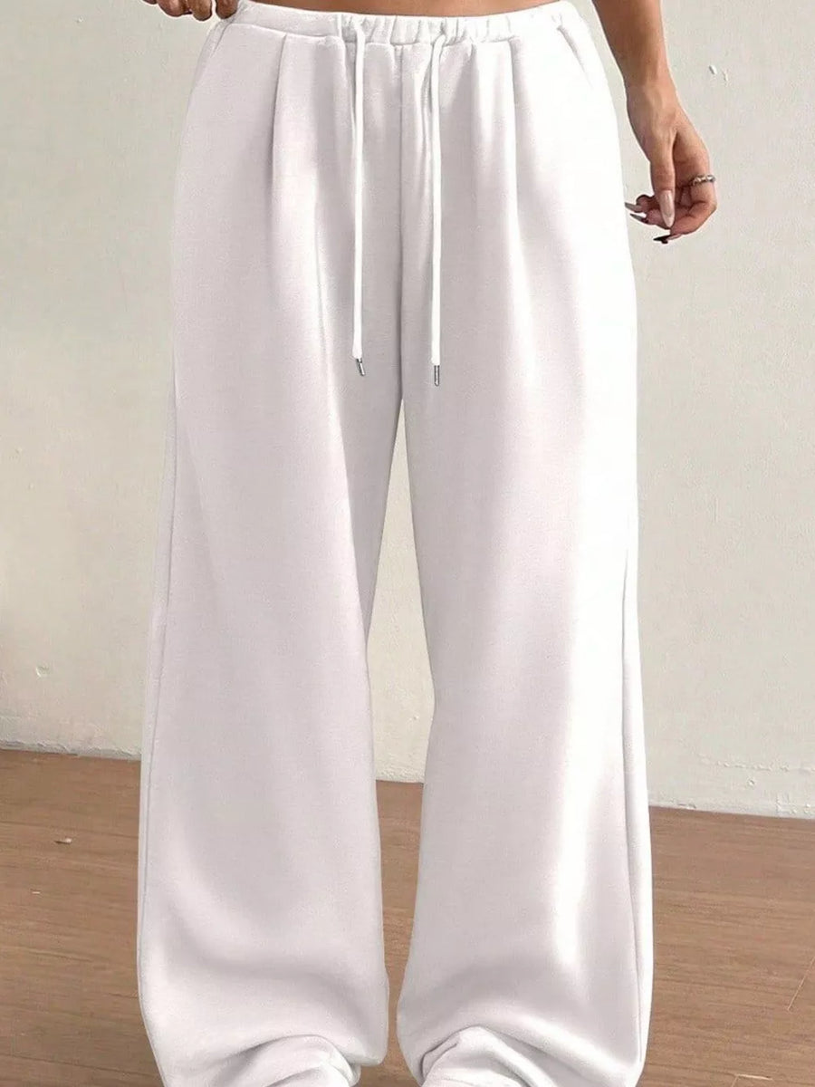White wide-leg maternity joggers with drawstring waist and relaxed fit.