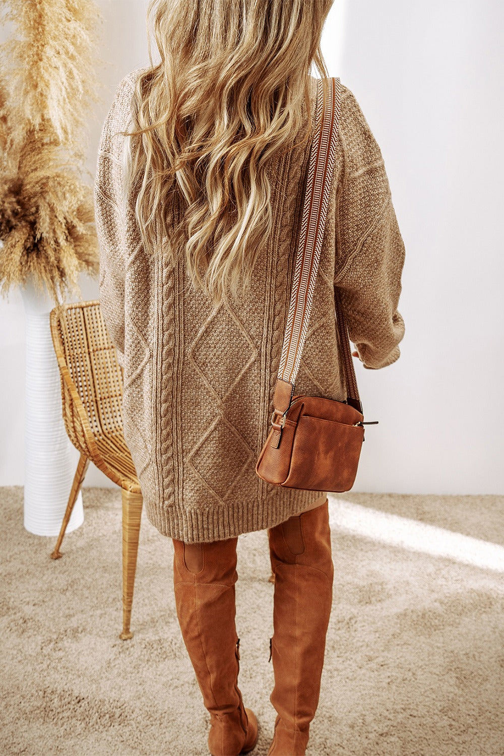 Tan cable knit sweater dress with diamond pattern, crew neck, and long sleeves.