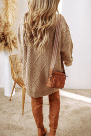 Tan cable knit sweater dress with diamond pattern, crew neck, and long sleeves.