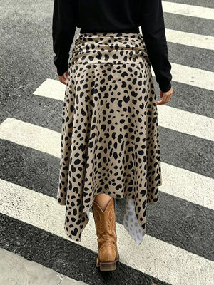 Leopard print midi skirt with asymmetrical hem and ruched waist, styled with cowboy boots.