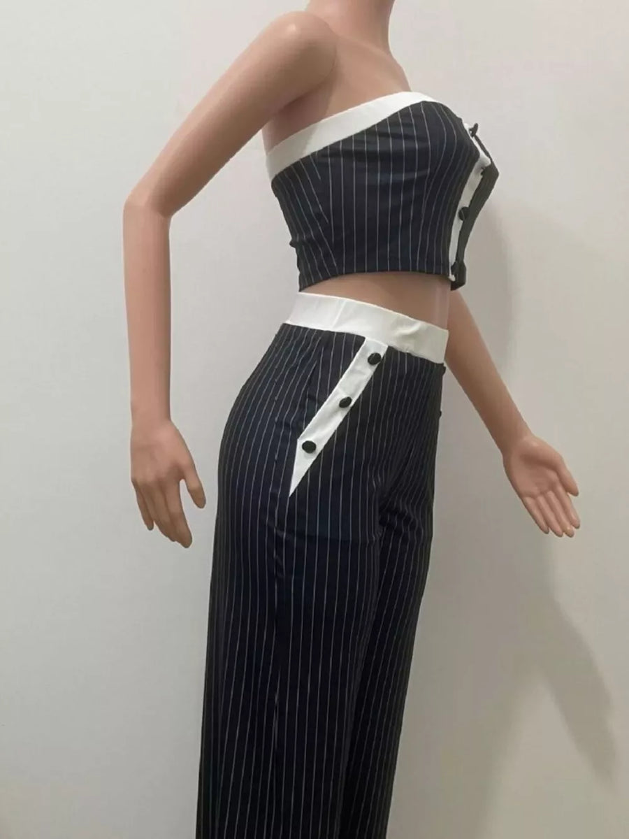 Black pinstripe strapless crop top and wide-leg pants set with white trim and button details.