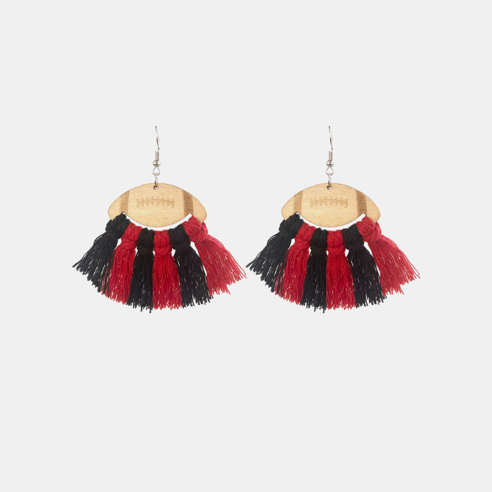 Macrame football tassel earrings in red and black with wooden football detail.