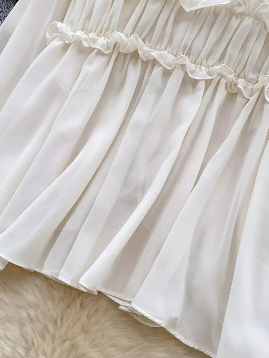 Delicate ruffled chiffon blouse in Card Color with tie-front detail.