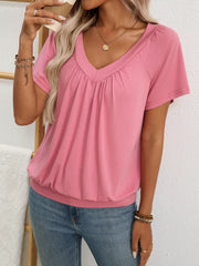 Pink ruched V-neck t-shirt with short sleeves and a banded hem.