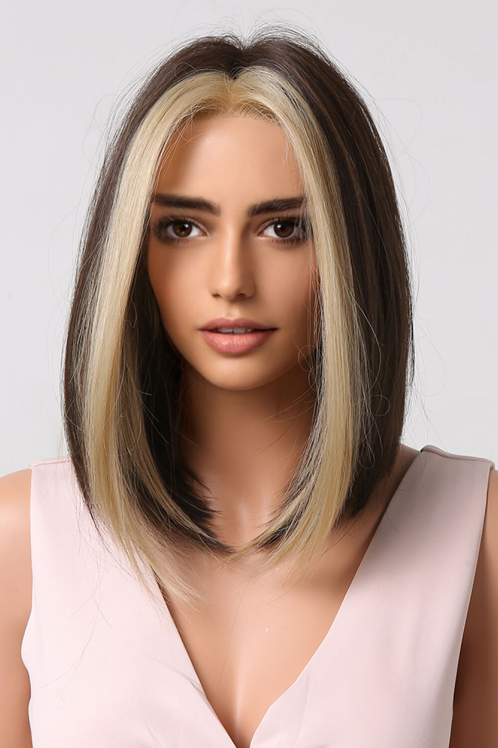 Two-tone bob wig in brown with blonde money piece, styled with face-framing layers.