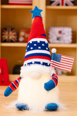 Patriotic gnome with red, white, and blue striped hat holding an American flag.