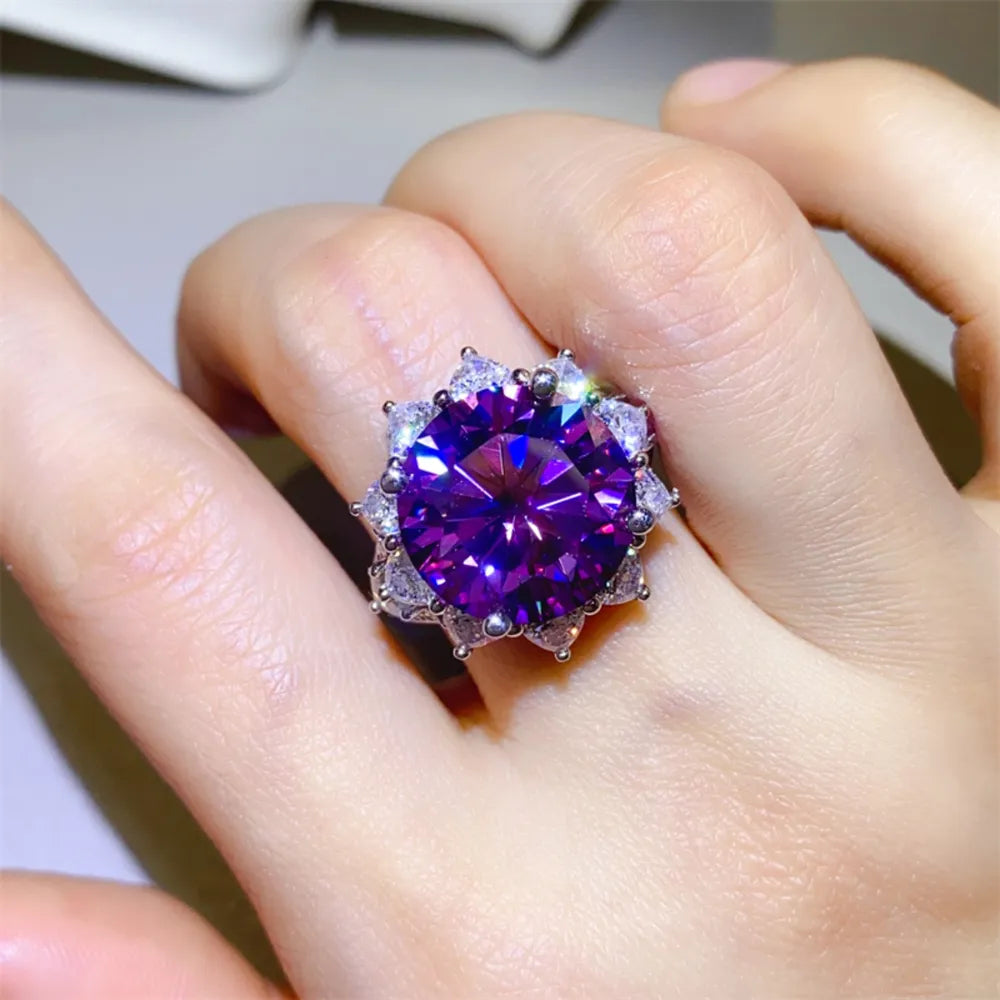 Amethyst sunburst moissanite cocktail ring with halo of smaller stones.