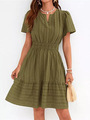 Textured army green V-neck tiered dress with smocked waist and short puff sleeves.
