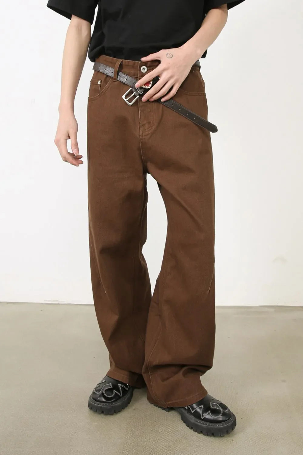 Coffee brown wide-leg denim jeans with angled seams and a relaxed fit.