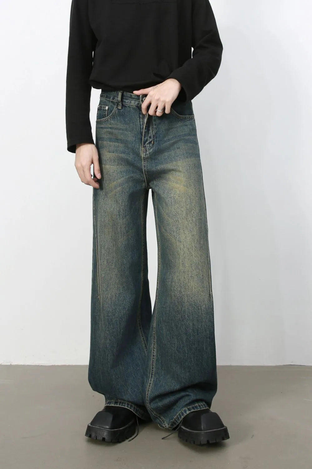 Dark wash wide-leg denim jeans with a relaxed fit and faded details.