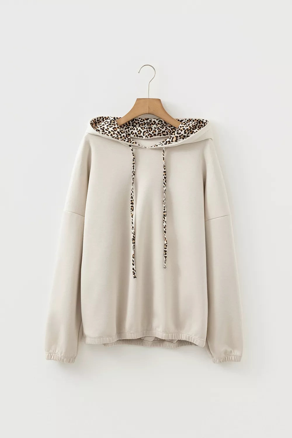 50% polyester, 45% viscose, 5% elastane Care instructions: Machine wash cold pullover hoodie in light beige with relaxed