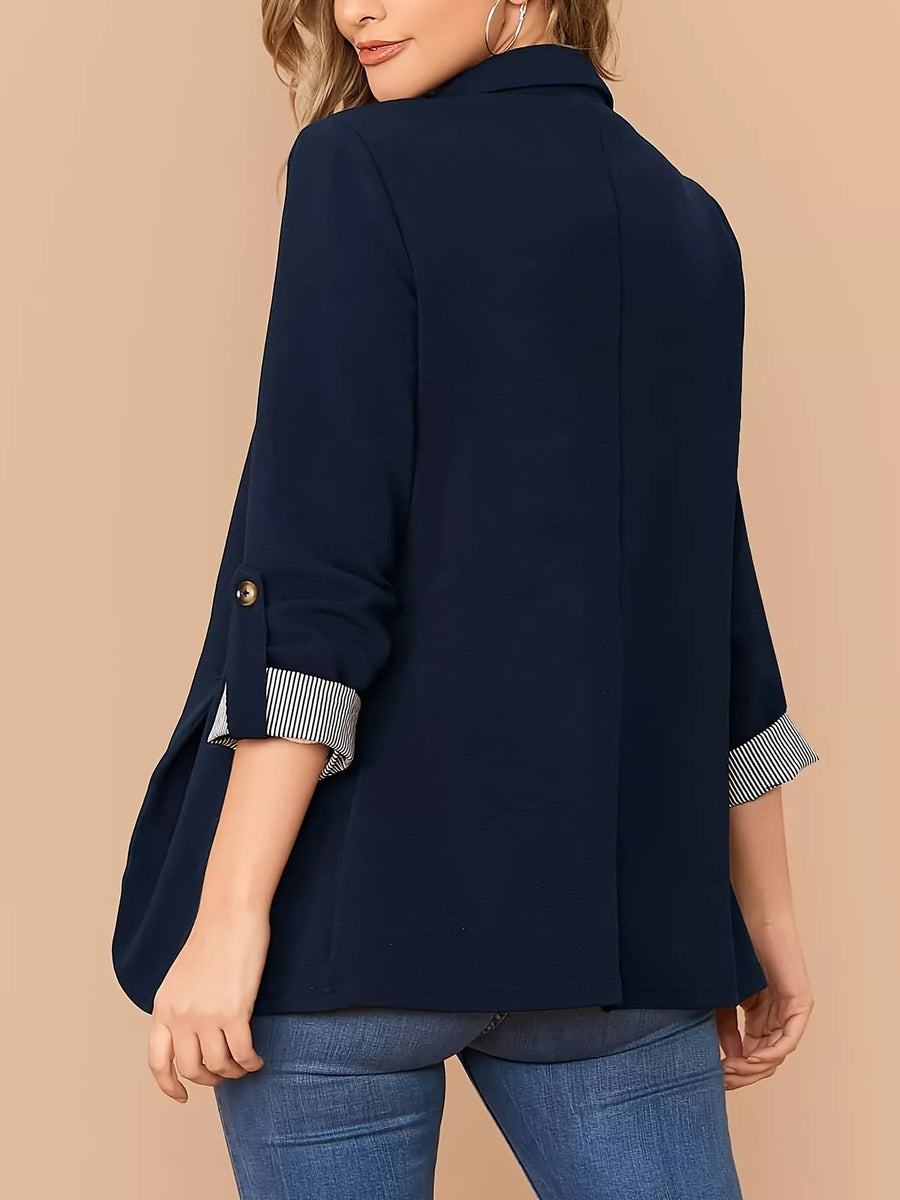 Navy blue blazer with roll-up sleeves featuring striped cuffs and a single button closure.