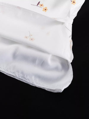 White floral print dress with a lightweight fabric and delicate stitching.