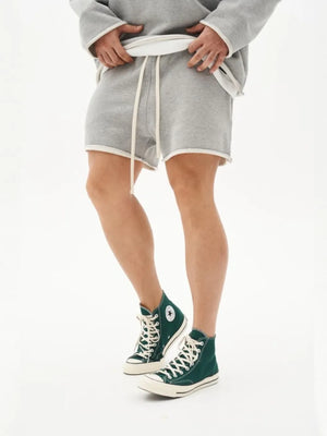 Gray fleece lounge shorts with raw edge hem and drawstring waist