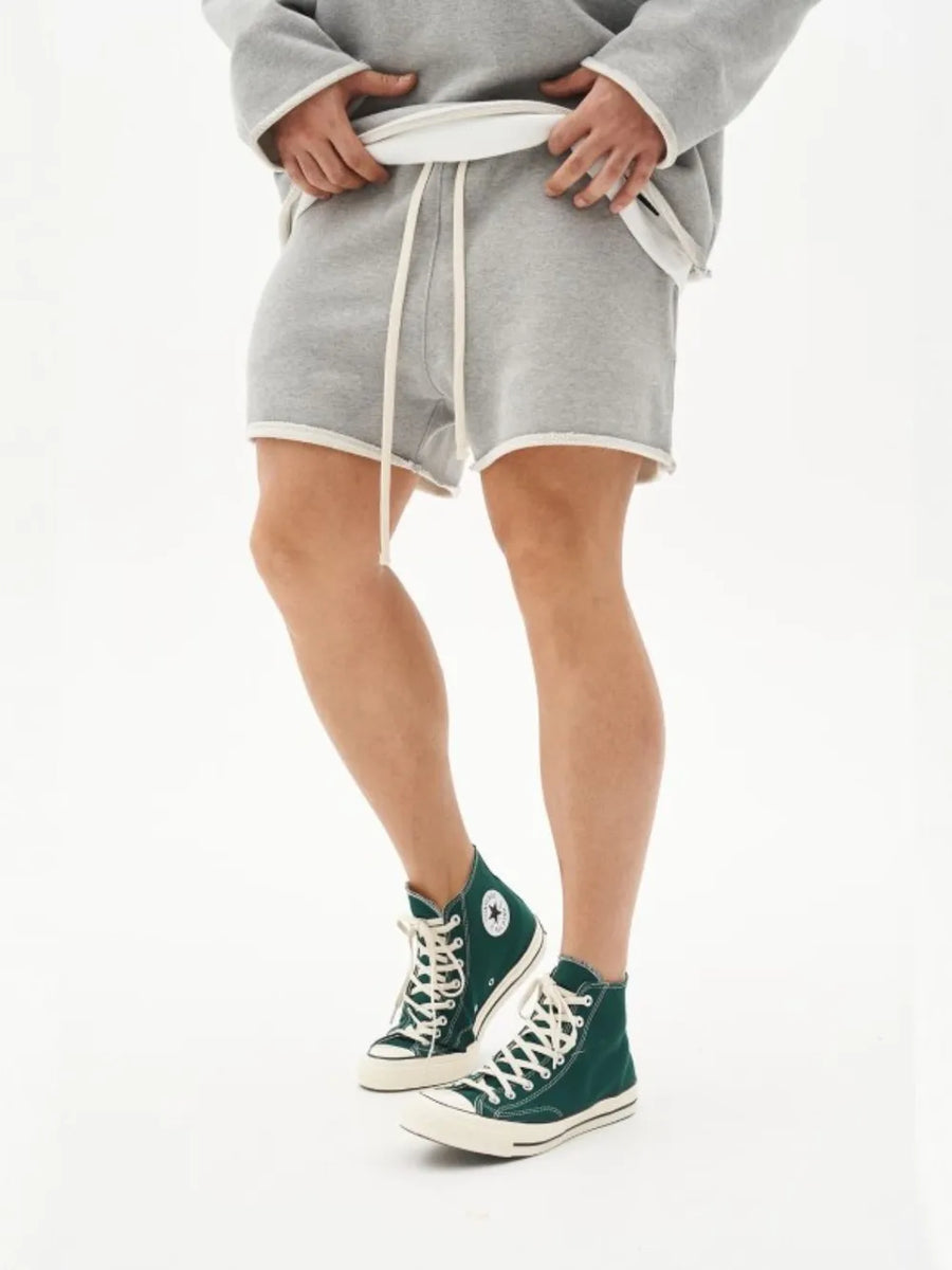 Gray fleece lounge shorts with raw edge hem and drawstring waist