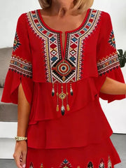 Red boho tiered dress with embroidered neckline and bell sleeves.