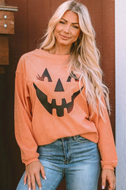 Caramel corduroy sweatshirt with a black jack-o'-lantern graphic and long sleeves.
