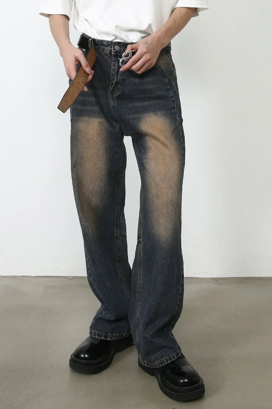 Baggy dark wash denim jeans with faded detailing and a relaxed fit.