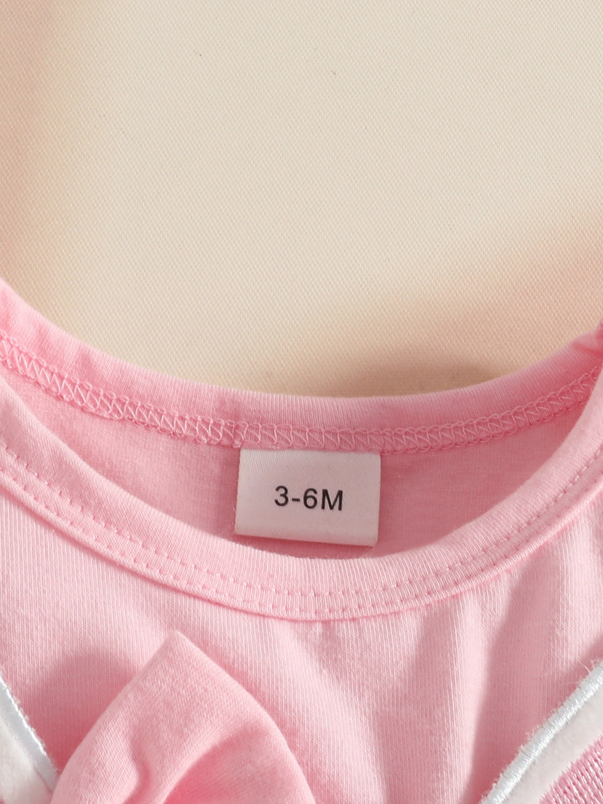 Pink baby dress with bunny applique detail and size tag 3-6M