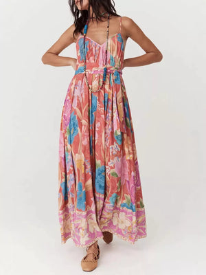 Maxi dress with spaghetti straps, V-neck, and a vibrant floral print.