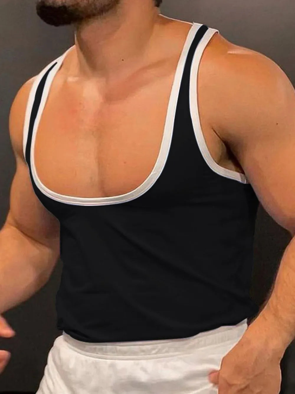 Black tank top with white contrast trim and scoop neck.