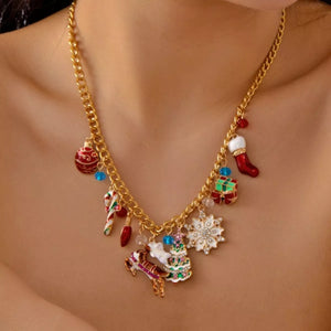 Gold charm necklace with festive Christmas icons including a stocking, tree, and reindeer.