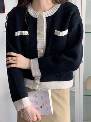 Black acrylic cardigan with contrast trim and button up front.