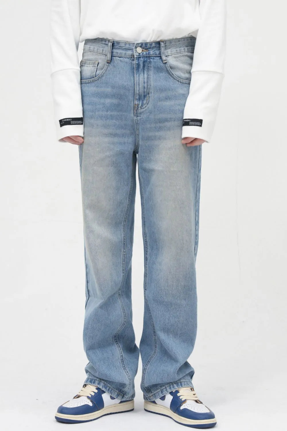 Faded wash relaxed fit jeans in medium blue denim with a casual, breathable style.